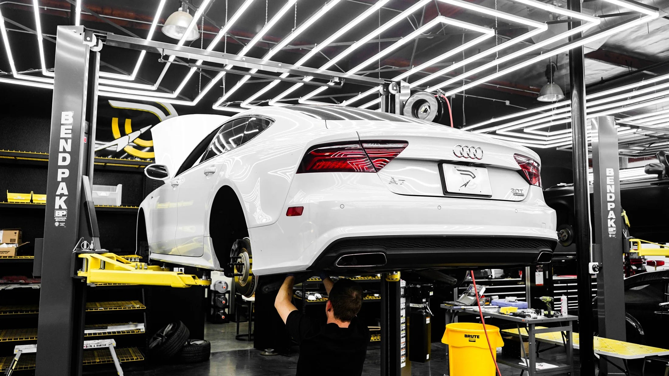 White Audi being serviced in a professional workshop